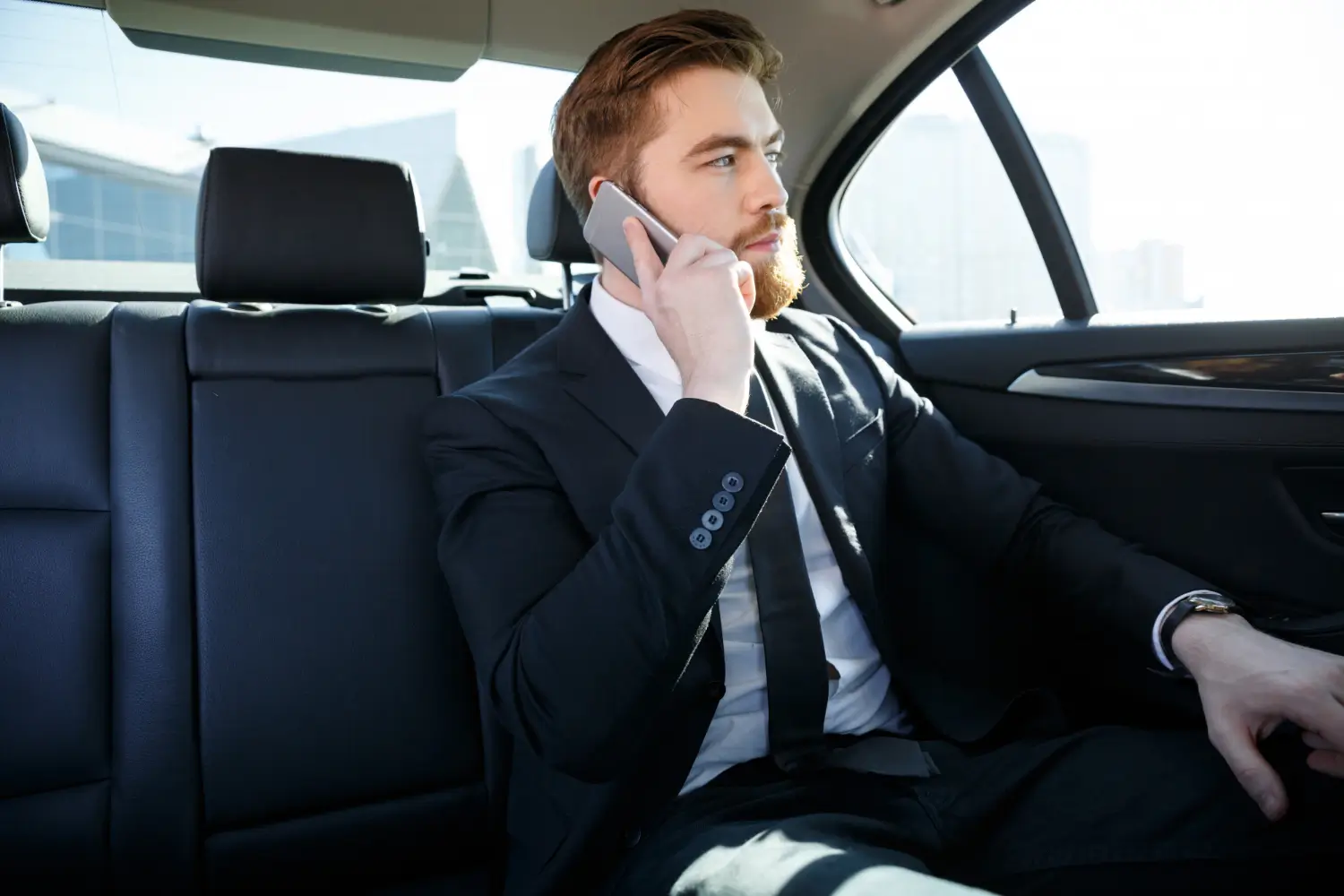 Chauffeur assisting passengers at Birmingham Airport